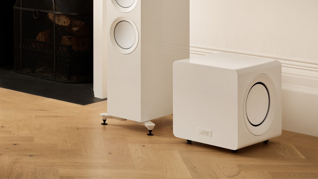 KEF KC92 Subwoofer placed a wooden floor next to a speaker
