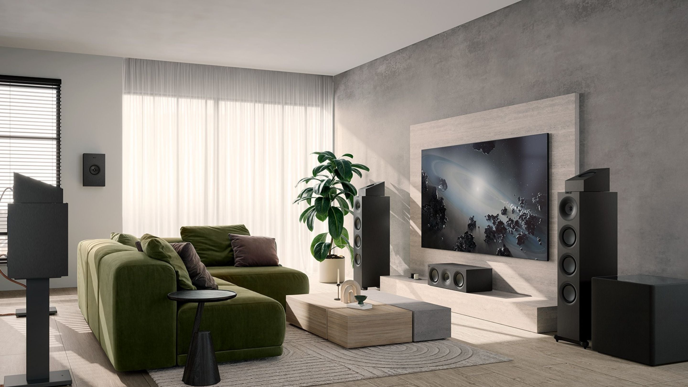 A modern living room featuring a green couch and a large television, with KEF Q Series Home theatre set-up