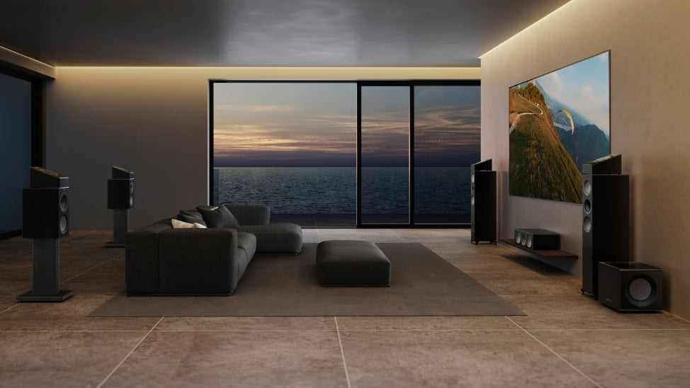 Home theatre setup with R Series speakers in living room with ocean view.