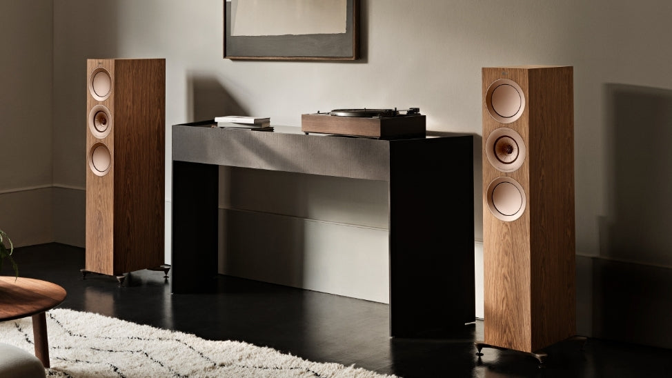 Pair of R Series floorstanding speakers in walnut in living room.